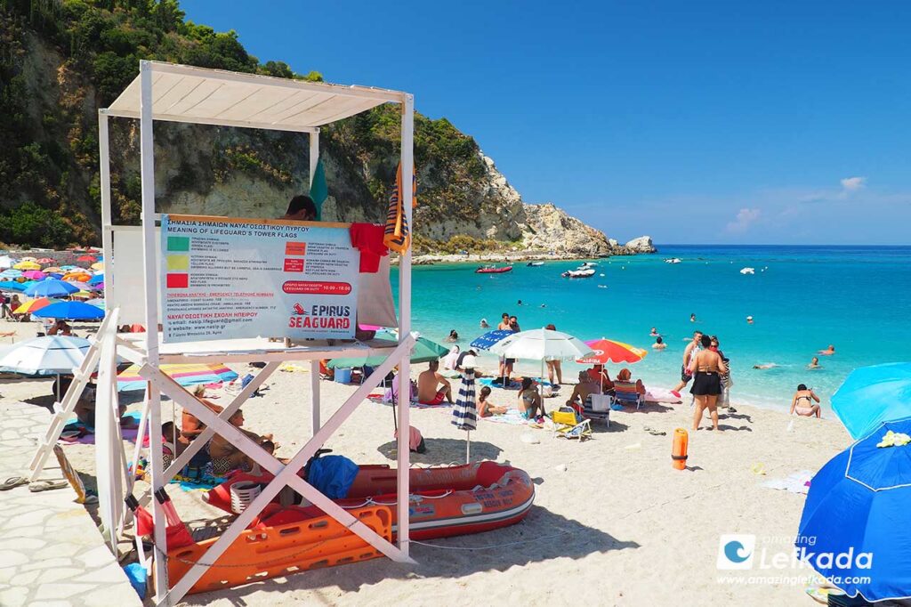 Agios Nikitas beach with sunbeds and swimmers