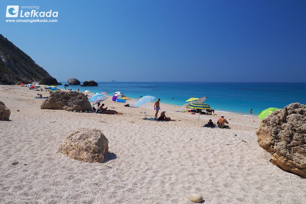 Visitors between rocks at Megali Petra beach Sunbathing at Megali Petra beach