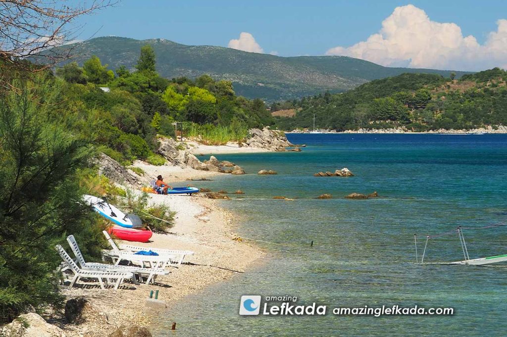 Shallow sea with sunbeds and sand at Lygia beach