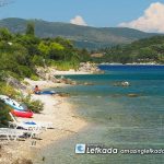 Shallow sea with sunbeds and sand at Lygia beach