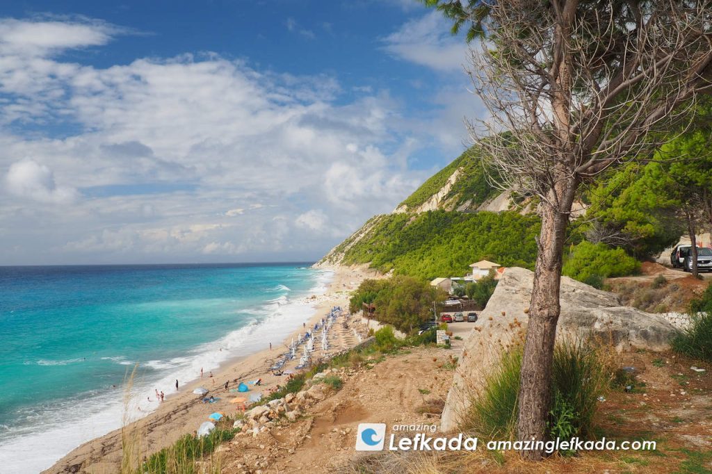 Blue colours of Paralia Pefkoulia beach in Lefkada Island with trees