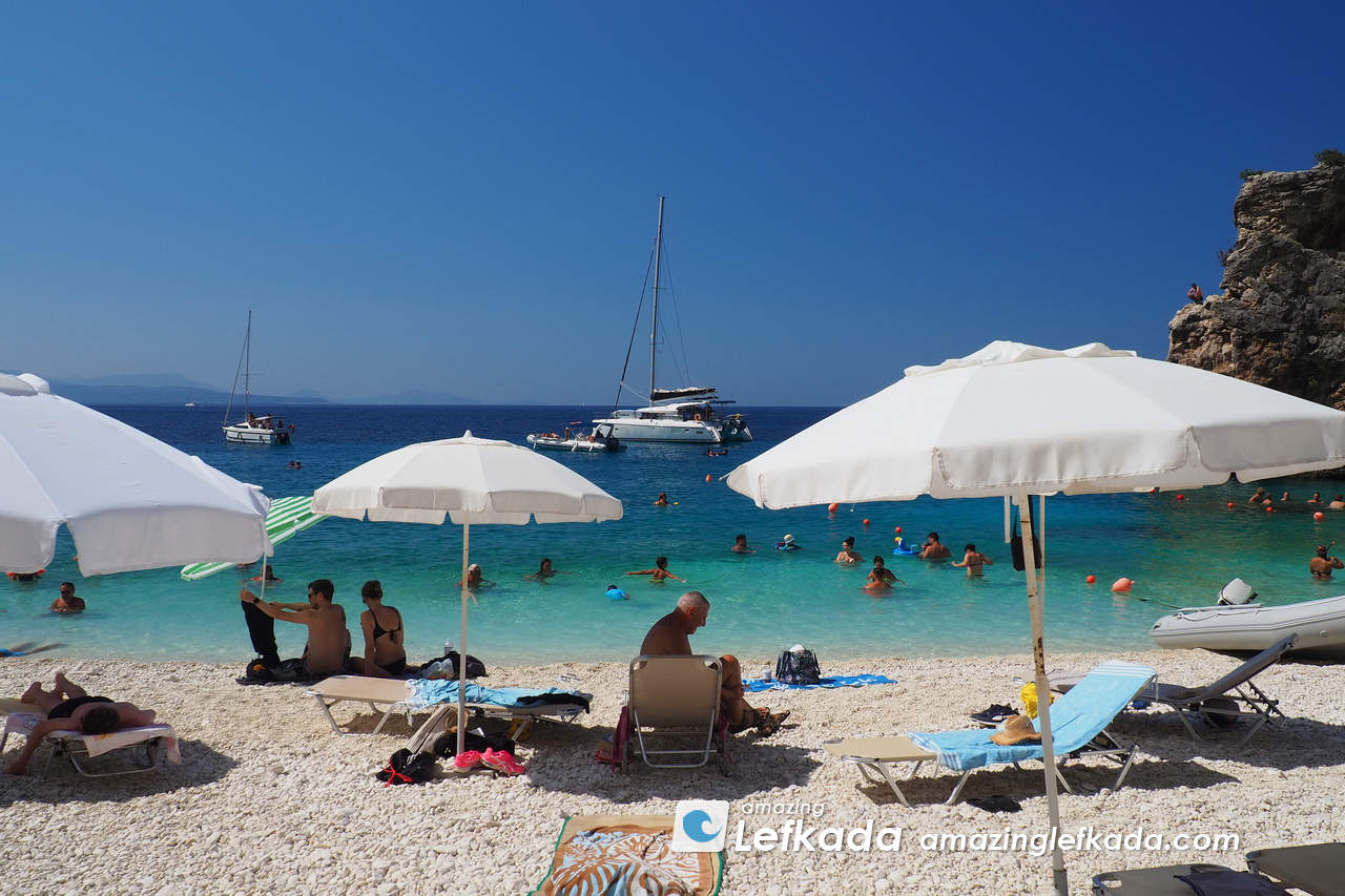 Blue sea and white umbrellas at Agiofili beach