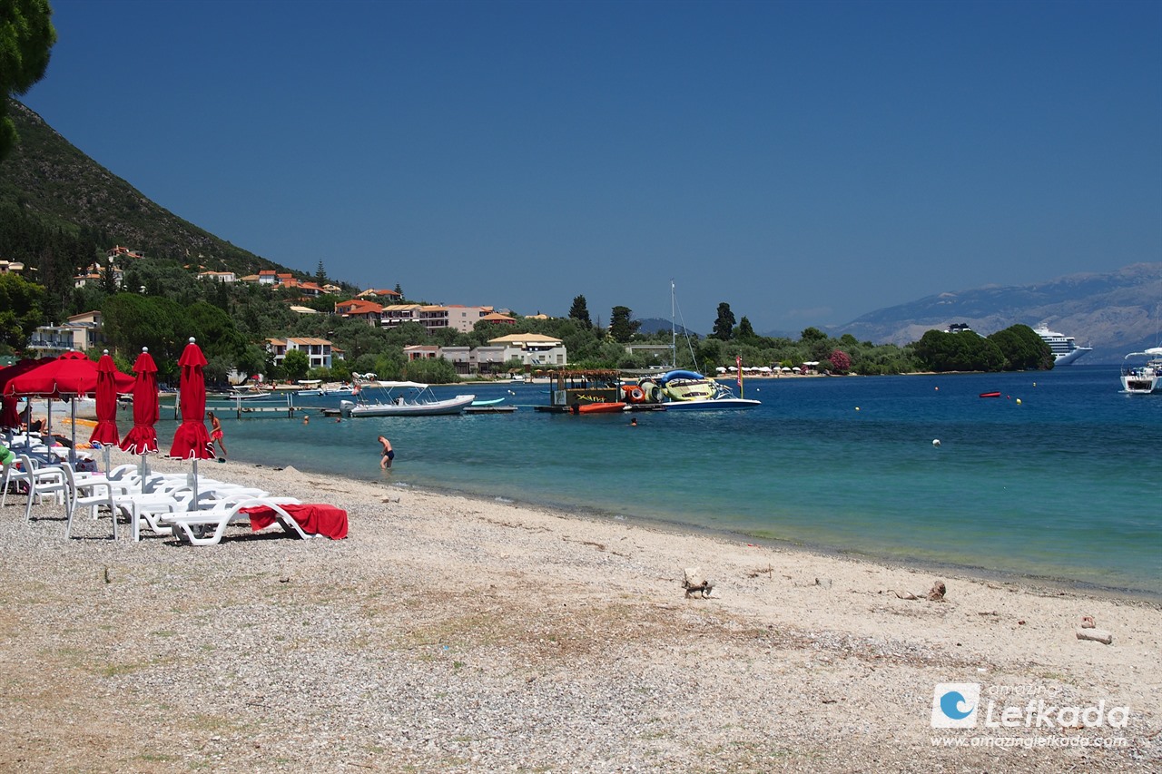 Sunbeds for rent at Paralia Nidri beach with coarse sand and calm sea in Lefkada Sunbeds for rent at Paralia Nidri beach with coarse sand and calm sea in Lefkada for children and kids