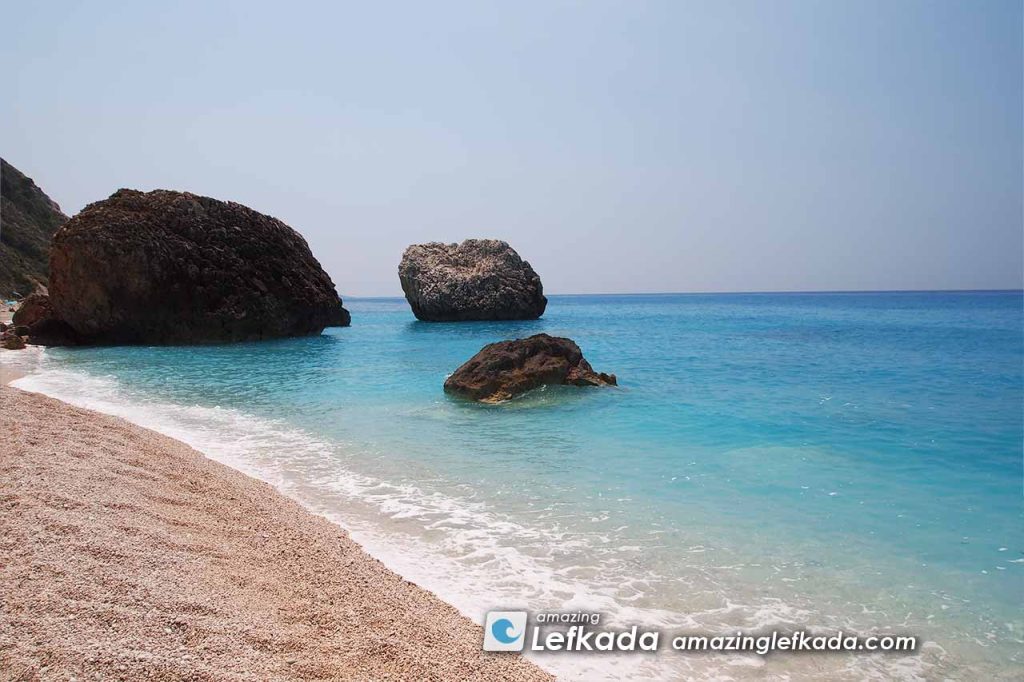 Rocks in the Ionian Sea and white sand