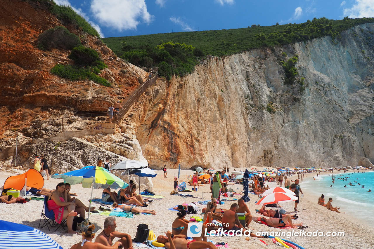 Visitors of Paralia Porto Katsiki beach with stairs, cliffs and pebbles