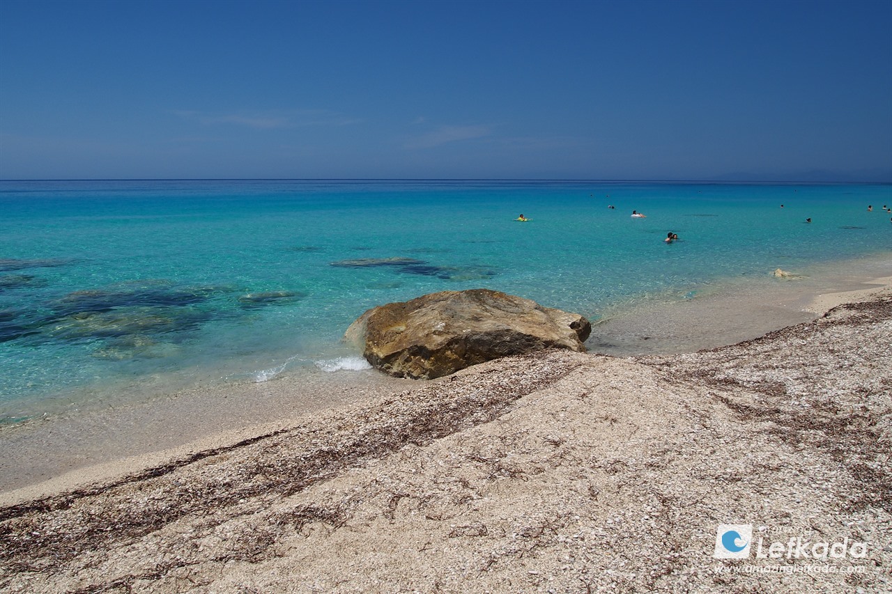 Crystal clear sea with warm sea temperatures, sandy coast of Pefkoulia beach in Lefkada