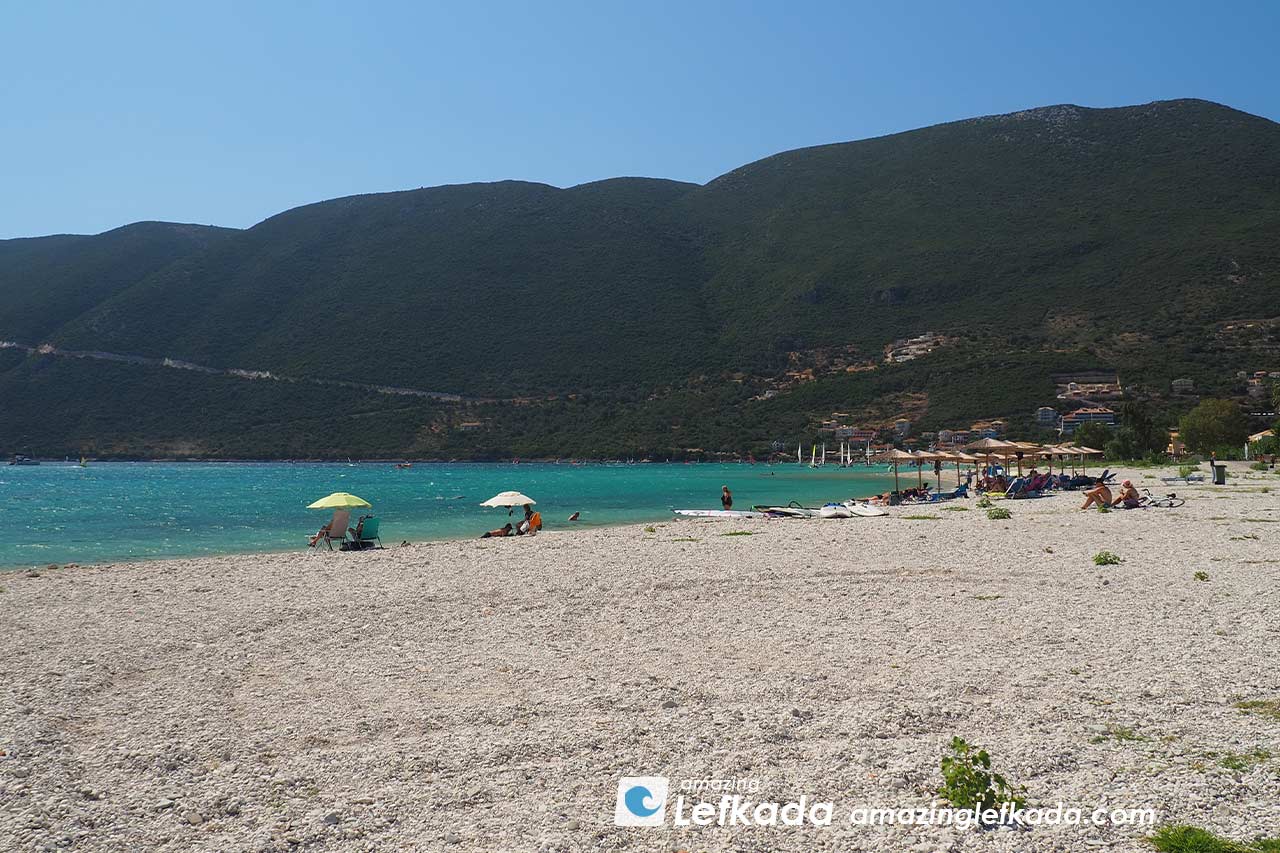 Paralia Vasiliki beach in Lefkada Island, Greece with sunbeds and parasols, restaurants near the sea
